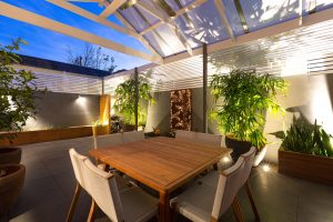 Outdoor Living Area with Backlit Screens and Outdoor Lighting