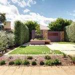 Landscaped Backyard with Hedge and Outdoor Features, Backlit Screen